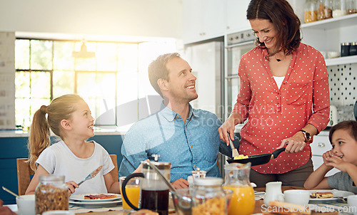 Image of Food, breakfast and morning with a family in the dining room of their home together for health or nutrition. Mother, father and sibling kids eating at a table in their apartment for love or bonding