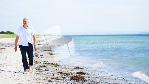 Image of Beach, walking and senior man on a travel tropical vacation, holiday or weekend trip in summer. Adventure, outdoor and elderly male person in retirement on the sand by the ocean or sea on getaway.