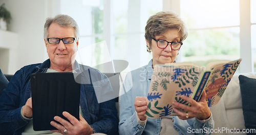 Image of Senior couple, reading book and tablet on sofa in home, relax and internet search on social media. Elderly man, woman and technology, knowledge and information in living room in retirement together