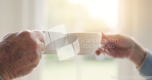 Image of Elderly couple, hands or tea toast in house to enjoy bonding, love or celebration together in retirement. People, coffee drink or man at nursing home to relax with a senior woman on break by window