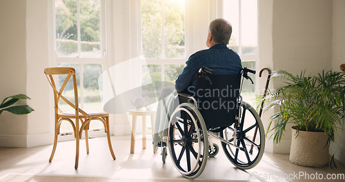 Image of Wheelchair, old man or thinking of memory by window in nursing home or retirement with depression. Nostalgia, sad or lonely elderly person in living room by an empty chair to remember past loss