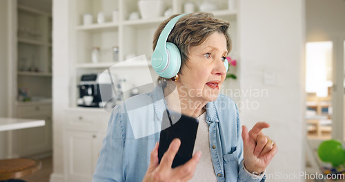 Image of Mobile, headphones or old woman listening to radio playlist to relax in house to enjoy retirement. Home, freedom or senior person on break dancing, singing or streaming music, song or audio alone