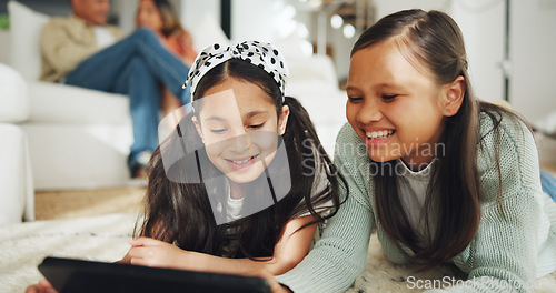 Image of Sisters, girls and tablet for streaming movies, series and playing games or online, social media on floor. Laughing, people and fun or smile, humor and comedy on technology, meme and website or silly