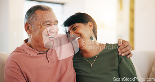 Image of Happy couple, together and embrace on sofa in living room with laugh for funny joke, conversation or talk. Senior man, woman and hug for love, care or support with marriage, bond and communication