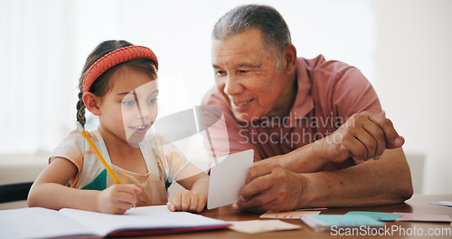 Image of Child, senior man and learning or reading, book and education at home, drawing and support or paper. Girl, grandfather and notebook or tutoring, assessment and smile for language or math homework