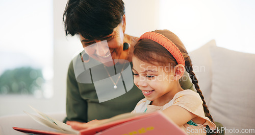 Image of Grandparent, kid and reading book with smile, home and child development, grandchild and couch. Woman, lounge or bonding together for relationship, family and retired with girl, house and happy