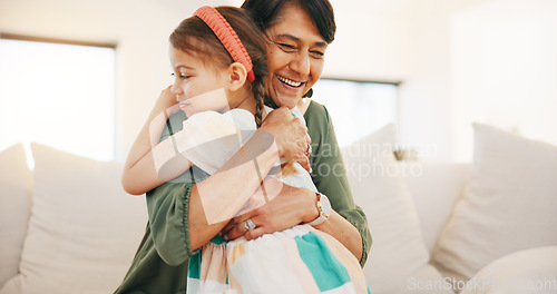 Image of Grandmother, child and hug on sofa in living room for love, care and bond for relationship. Senior woman, little girl and smile in happiness for memory, moment or support while babysitting at home