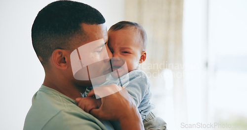 Image of Hug, comfort and father with crying baby in a nursery with care, security and trust at home together. Love, tears and dad embrace upset newborn with colic, stress or discomfort, console or nurture