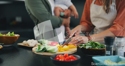 Image of Hands, knife and vegetables on chopping board, cooking and preparation at home. Closeup of mother cutting pepper in kitchen, organic salad and family food for healthy vegan diet, nutrition and dinner