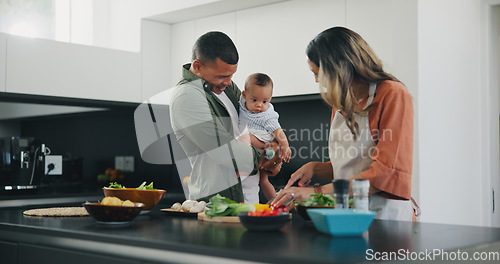 Image of Happy, couple and baby cooking vegetables in kitchen for nutrition food, child development or parent connection. Man, woman and boy in home for meal prepare or health wellness, ingredients for dinner