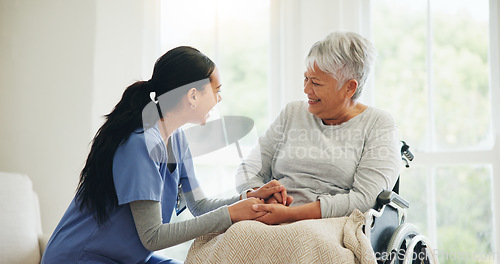 Image of Happy woman, doctor and holding hands with senior patient in wheelchair, support or trust for healthcare at home. Medical nurse, caregiver or person with a disability smile for care or help at house