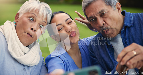 Image of Selfie, peace sign or funny face with a nurse and old couple outdoor in an assisted living garden together. Comedy, support or wellness with a senior man, woman and young caregiver in the backyard