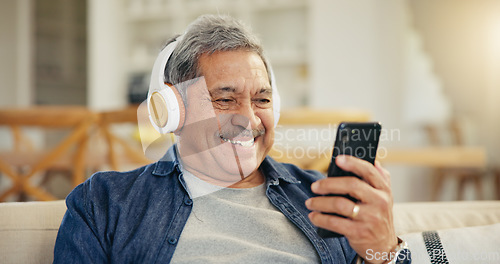 Image of Senior, happy man and headphone for video call in living room by internet, web or app. Elderly person, smile and technology for connectivity, cellular or network with mobile for communication in home