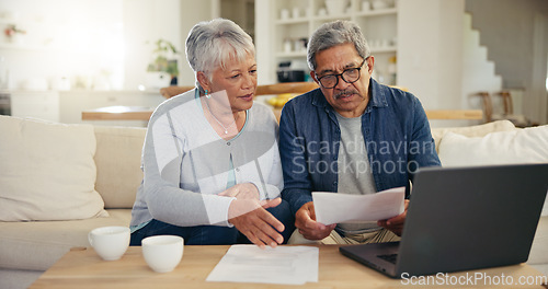 Image of Elderly, couple and documents for financial planning in home with laptop, internet and reading for account balance. Senior man, woman and discussion with tech, webpage or online banking for budget