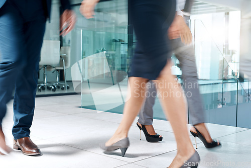 Image of Business people, busy or legs walking in office in commute to travel together for work or job. Closeup, shoes or group of employees in lobby of workplace with suit, blur or fast and corporate staff