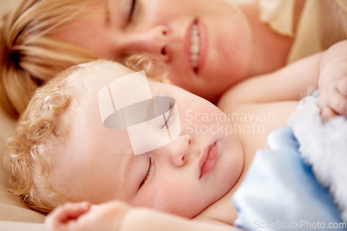 Image of Sleeping, mom and calm baby in bed together with peace, happiness and love for infant in morning nap. Mother, cuddle and sleep with child in closeup and rest with a smile in bedroom or family home