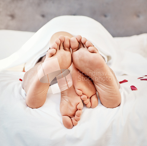 Image of Intimate couple bare feet in bedroom for love, valentines day and sexual partner with passion at home. Closeup of erotic man, woman and foot for morning intimacy, relax marriage and sleeping together