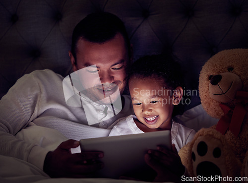 Image of Man, child and digital tablet streaming movies, cartoon or game in bed at night. Happy father and son browsing the internet, online or web with social media app while watching a comedy in the bedroom