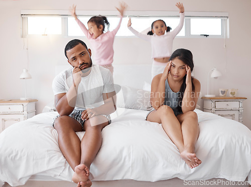 Image of Autism, headache and children with tired parents in their bedroom at home with adhd kids jumping on the bed. Family, noise and stress with a sad man and woman looking exhausted with no energy