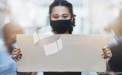 Image of Activism, protest and girl with a poster with copy space in a street with face mask during pandemic. Portrait of human rights activist protesting with a empty sign for equality or justice in the city