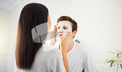 Image of Couple facial in bathroom, beauty mask cleanser on man face and skincare wellness product. Cosmetic cleaning, young marriage together and beautiful woman showing self love and relax in home together