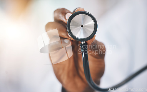 Image of Stethoscope, healthcare and medicine with the hand of a doctor listening to a heartbeat or breathing in a hospital. Medical, insurance and consulting with a medical or health professional in a clinic