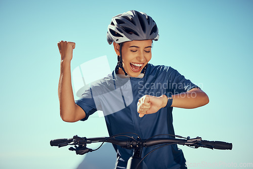 Image of Cycling watch time, happy woman and success, winner achievement and progress for triathlon competition race. Professional bicycle athlete, fitness smartwatch and fist celebration for sports training