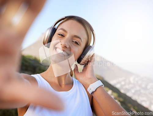 Image of Social media, influencer and portrait of woman listen to music and creating online content of scenic mountain views. Fitness, travel and blog with a happy, relax girl posing for a photo in zen nature