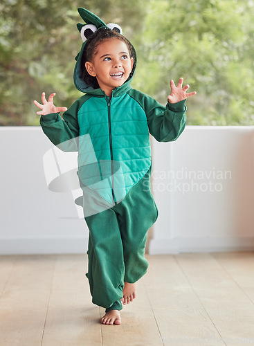 Image of Child, smile and excited in halloween dinosaur costume at home playing role and having fun at party. Happy kid being playful with fantasy character in living room mimic animal actions ready to roar.