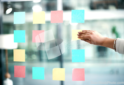 Image of Business woman planning company growth and strategy by arranging sticky notes and managing her schedule. Closeup of an employee brainstorming ideas for a startup mission or vision