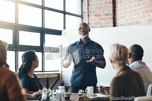 Image of Senior business man doing presentation, planning and talking in a meeting, seminar or training workshop in a boardroom. Manager sharing ideas, teaching and coaching new employees during conference