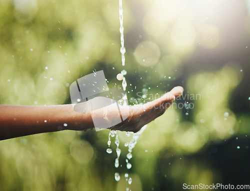Image of Hygiene, washing and saving water with hands against a green nature background. Closeup of one person holding out their palm to save, conserve and refresh with water in a park, garden or backyard