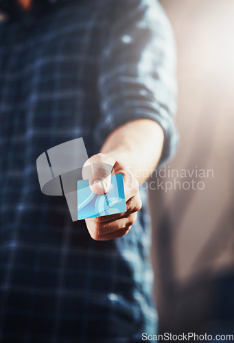 Image of Male customer holding his credit card in his hand to complete and pay for his shopping purchase. Guy choosing an electronic finance payment method for paying. Retail shop client ready to spend money