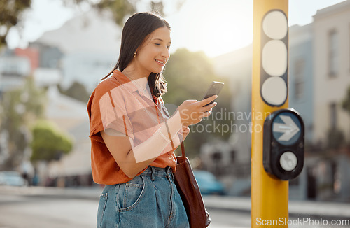 Image of Texting on a phone, browsing social media and waiting for public transport and commuting in the city. Young female tourist enjoying travel and Looking online for places to see and visit on holiday