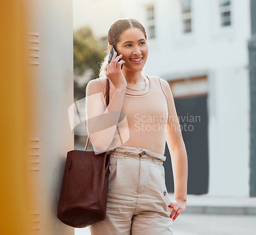 Image of Casual woman talking on phone call, networking and making conversation while standing in the urban city alone. Trendy, smiling and cheerful female commuting and traveling to work in the morning