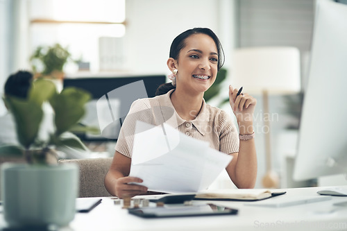 Image of Finance manager, businesswoman or financial analyst budgets on a computer with paperwork. Young smiling accountant, insurance advisor or investment planner working on tax, bills or accounting papers