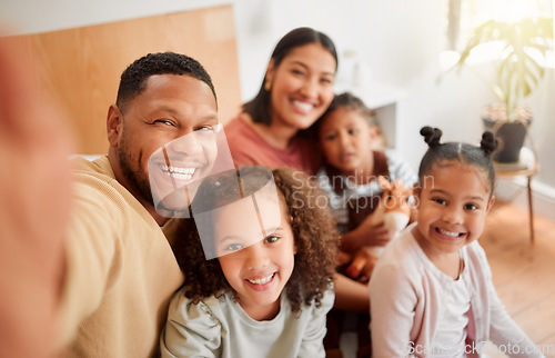 Image of Happy family taking selfie, having fun, relaxing and bonding in living room at home. Smiling, carefree parents enjoying time with children indoors, being affectionate and together on the weekend