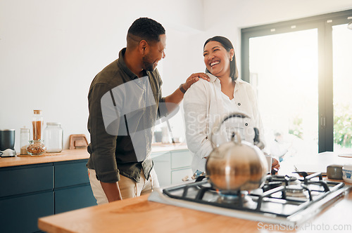 Image of Joyful and loving couple bonding and having fun while spending time together in the kitchen. Smiling, in love and carefree couple laughing, sharing a romantic moment while enjoying the morning