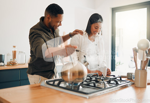 Image of Loving couple having coffee or tea, relaxed and carefree while bonding in a kitchen at home. Caring husband being affectionate, talking and enjoying their relationship and quiet morning with his wife