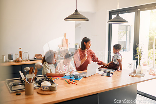 Image of Caring parent tutoring and teaching her small children with after school activity. Loving mother taking care of young kids and helping with class homework projects in the kitchen of their family home