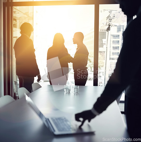 Image of Planning strategy for a successful and bright future with a team of business people talking in a boardroom meeting with flare. Backlit group of corporate professionals discussing in the office