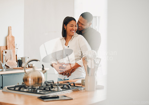 Image of Loving, happy and hugging couple relaxing in the kitchen at home smiling and laughing together. Carefree, excited and affectionate lovers having fun and enjoying quality time in the house