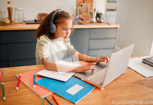 Image of Child education, learning and listening with laptop and headphones for online interactive activity or distance teaching lesson at home. A little, smart and modern student busy with an assignment test