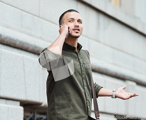 Image of Lost man, traveler or tourist talking on a phone call asking for directions in a new city. A confused young male on vacation in an urban town looking around to find his hotel or the airport