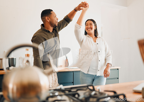 Image of Dance, love and happy couple having fun, romance and bonding while laughing, spinning and twirling together at home. Loving husband enjoying care, smile and dancing while relaxing with playful wife