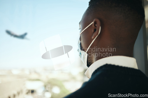 Image of Businessman in an airport for work travel during covid with a mask and plane fly in the background. Entrepreneur, employee or corporate professional watching an airplane while waiting to board flight