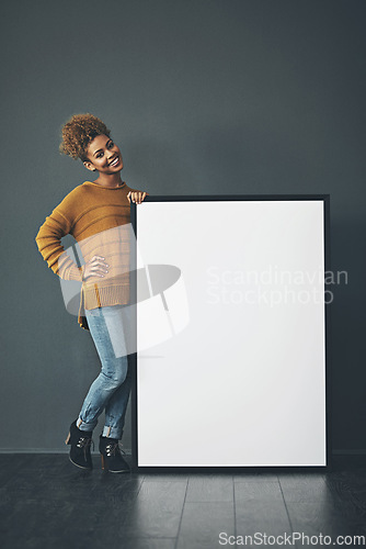 Image of Young woman holding and showing an empty or blank sign for voicing an idea or advertisement announcement. Happy, excited and cheerful designer standing with mockup whiteboard or copyspace banner.