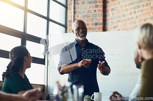 Image of Senior businessman doing a presentation talking or explaining business KPI report, workflow management and strategy for teamwork interaction. Successful corporate manager at economic forecast meeting