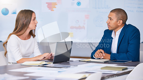 Image of Collaboration, teamwork and planning team of social media marketing and advertising professionals talking in strategy meeting. A man and woman working on a messy office, workstation or workplace desk