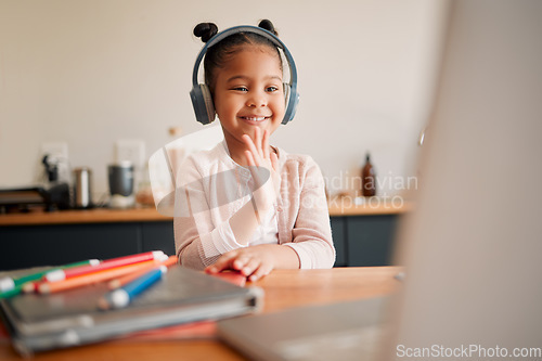 Image of Distance learning, education and virtual student child on a video call lesson with a headset and laptop doing hello or bye greeting gesture. Little girl in an online classroom, homeschooling at home